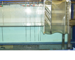 Breaking wave impact on a ‘deformable’ truncated vertical wall (CCP-WSI Comparative Study 1)